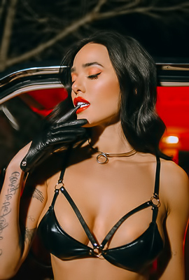 Smoking by the Red Light: Lily Andrews Poses Solo in Tattooed Leather